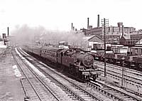 Ex LM&SR Fowler 2-6-4T 42311 heads a SO Bradford-Manchester express past Castleton East Junction in 1960. The building visible above the loco was formerly a M&LR engine shed before conversion to a goods shed in the 1880's. Richard S. Greenwood